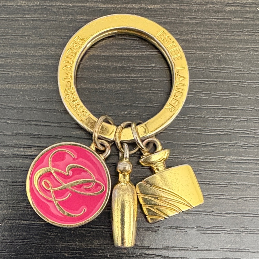 Estee Lauder Gold Tone Key Ring with Pink Enamel Logo Charm